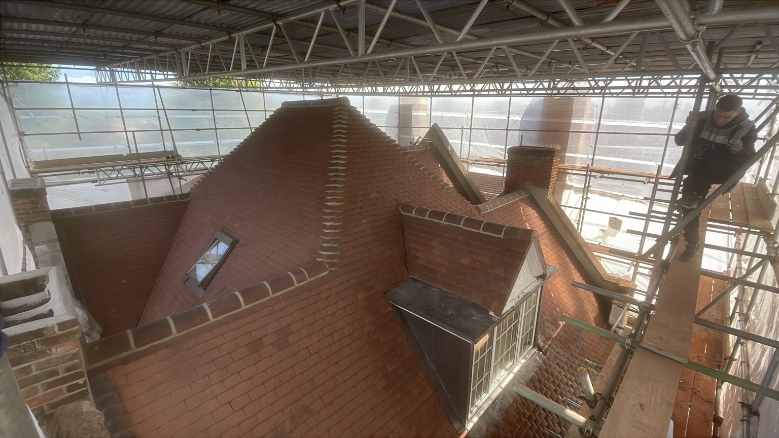 Roofing work under scaffolding